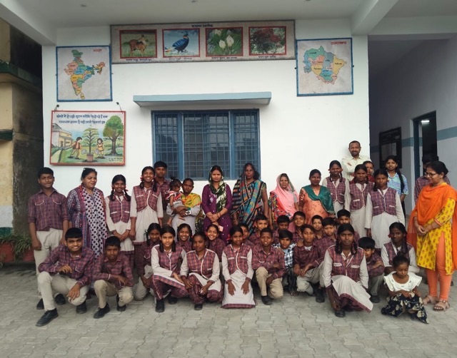 Aasraa Trust students and teachers outside their school classroom